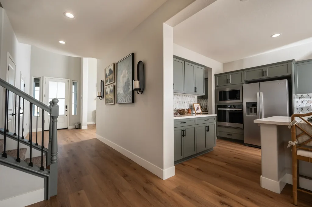 Interior - wrought-iron staircase railings, luxury vinyl flooring, open kitchen with island